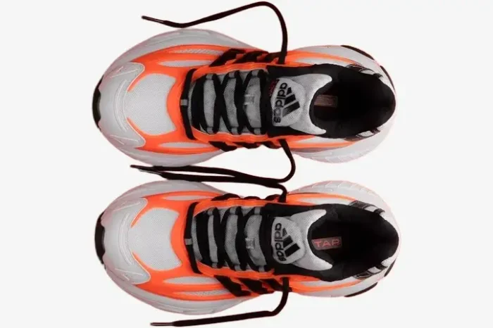 Top-down view of Adidas Adistar Jellyfish x Pharrell x VIRGINIA sneakers in white and orange. - SKU JP9261