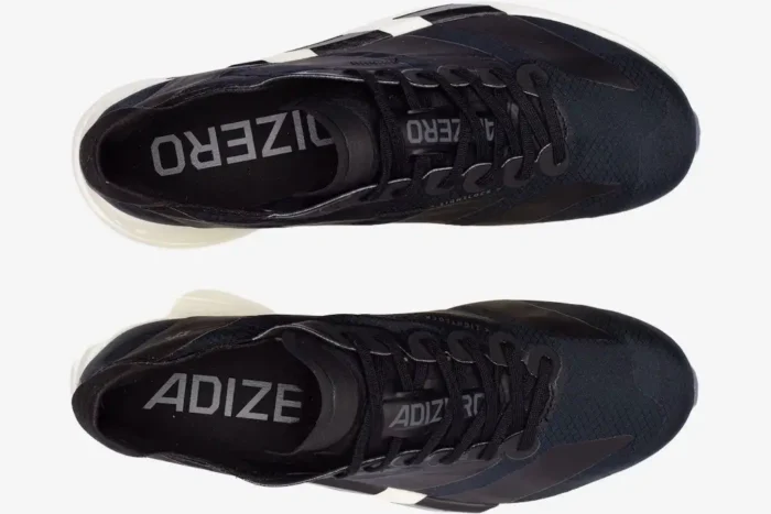 Top-down view of black Adidas Adizero Adios Pro 4 running shoes with white midsoles. - SKU JR6369