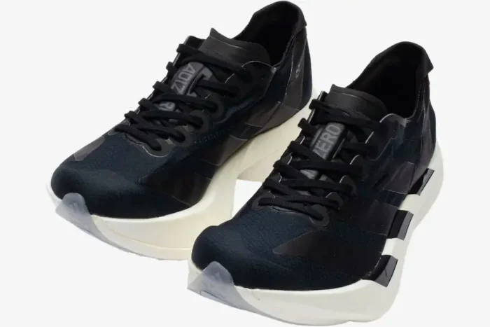 Adidas Adizero Adios Pro 4 running shoes in black and white, shown from a three-quarter front angle. - SKU JR6369