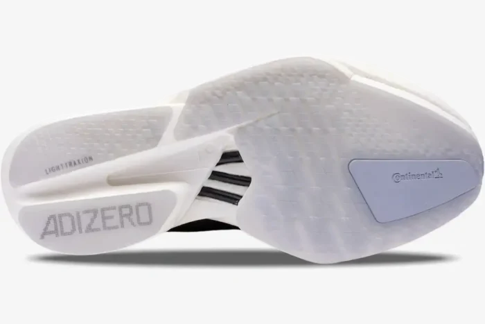 Bottom outsole view of Adidas Adizero Adios Pro 4 running shoe in black and white. - SKU JR6369