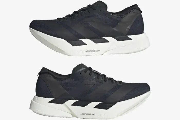 Lateral and medial side profile views of black and white Adidas Adizero Adios Pro 4 running shoes. - SKU JR6369