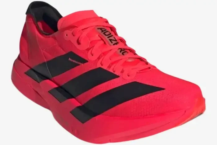 Adidas Adizero Adios Pro 4 running shoe in red and black, three-quarter front view. - SKU JR6368