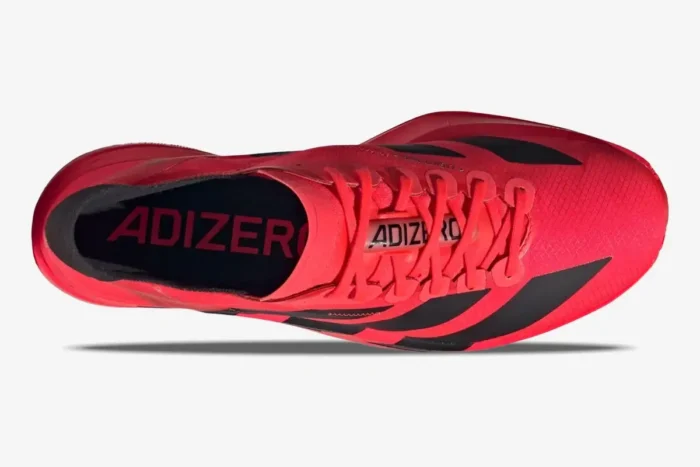 Top-down view of the red and black Adidas Adizero Adios Pro 4 running shoe with red laces. - SKU JR6368