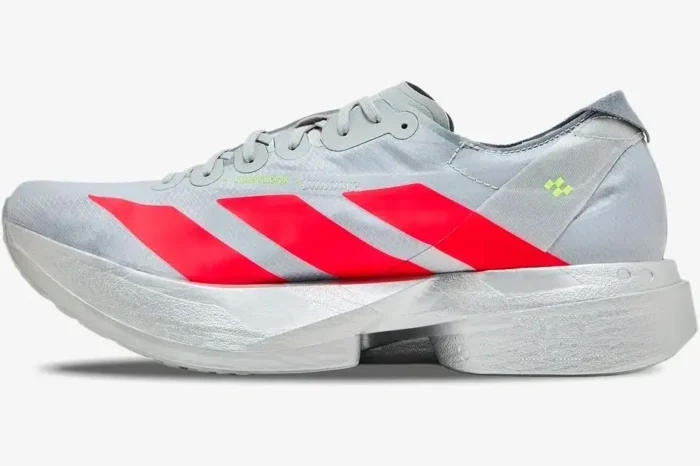 Side profile of Adidas Adizero Adios Pro 4 running shoe in silver with bold red stripes. - SKU JR6357