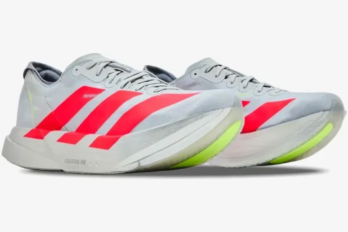 Adidas Adizero Adios Pro 4 running shoes in silver and red, shown from a three-quarter side angle. - SKU JR6357