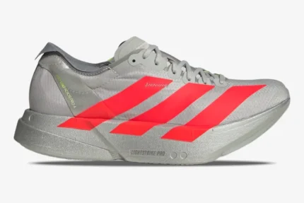 Side profile of silver Adidas Adizero Adios Pro 4 running shoes with vibrant red stripes. - SKU JR6357