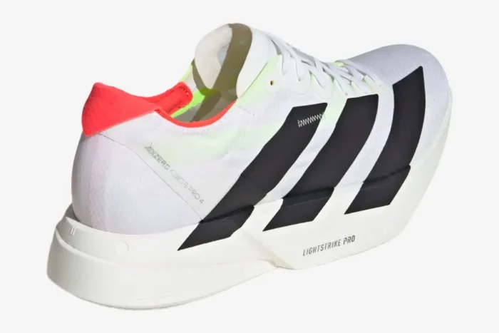 Rear perspective of Adidas Adizero Adios Pro 4 running shoe in white and black with a red heel tab. - SKU JR1094