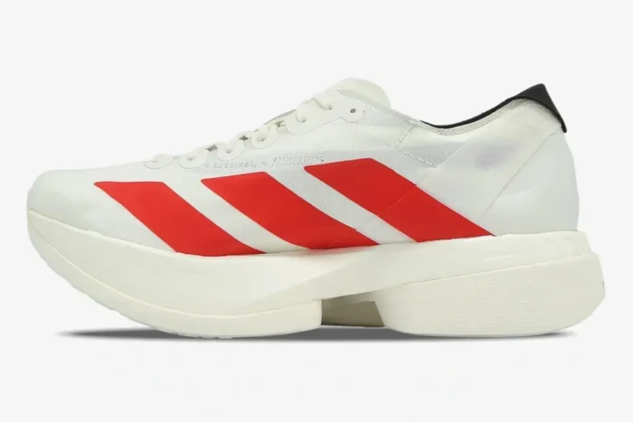 Side profile of the Adidas Adizero Adios Pro 4 running shoe in white with bold red stripes. - SKU JR6363