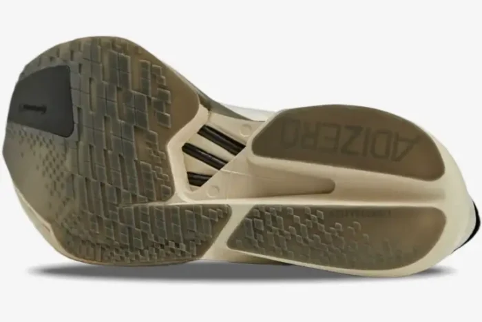 Bottom outsole view of Adidas Adizero Adios Pro 4 x Y-3 in Alumina Cinder, featuring carbon rods and traction. - SKU JS3154