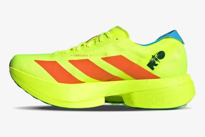 Side profile of Adidas Adizero Adios Pro 4 running shoe in neon yellow with orange stripes. - SKU JQ1571