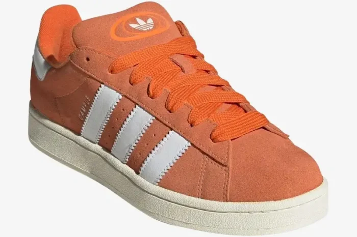 Adidas Campus 00s sneakers in amber tint orange and white, shown from a three-quarter side angle. - SKU ID1436