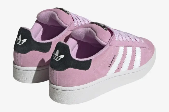 Rear view of Adidas Campus 00s Bliss Lilac sneakers with pink suede, white stripes, and black heel tabs. - SKU HP6395