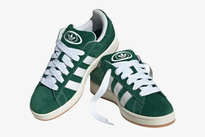 Pair of Adidas Campus 00s sneakers in dark green suede with white stripes, three-quarter front view. - SKU JK4971