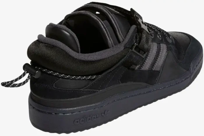 Rear view of black Adidas Forum Buckle Low x Bad Bunny sneakers with heel toggle and buckle strap. - SKU GW5021