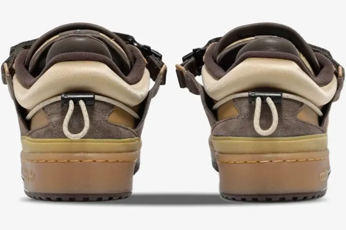 Rear view of brown Adidas Forum Buckle Low x Bad Bunny Café sneakers showing heel toggles and gum soles. - SKU GW0264