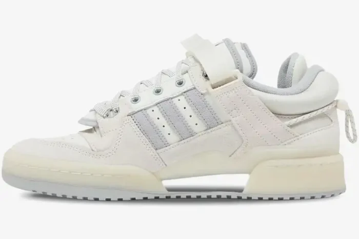 Side profile view of Adidas Forum Buckle Low x Bad Bunny sneakers in white cream colorway. - SKU HQ2153