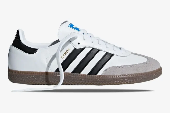 Side profile of Adidas Samba OG sneakers in white with black stripes and a gum brown sole. - SKU JK3367