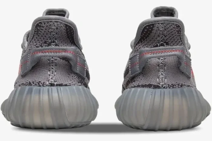 Rear view of Adidas Yeezy 350 V2 Beluga 2.0 sneakers in grey with red-stitched heel tabs and ribbed midsoles. - SKU AH2203