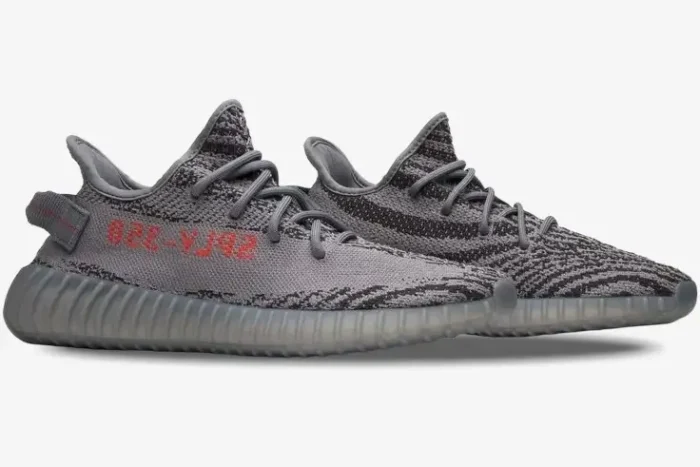 Side profile of Adidas Yeezy 350 V2 Beluga 2.0 sneakers in grey with orange SPLY-350 branding. - SKU AH2203