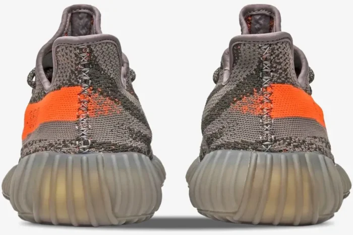 Rear view of Adidas Yeezy 350 V2 Beluga OG sneakers featuring grey Primeknit and a bright orange stripe. - SKU BB1826