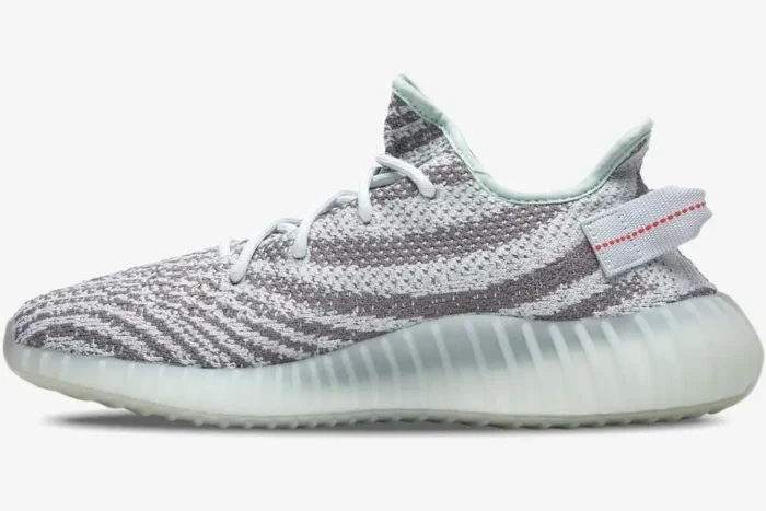 Side profile of Adidas Yeezy 350 V2 Blue Tint sneakers featuring a grey and light blue patterned Primeknit upper. - SKU B37571
