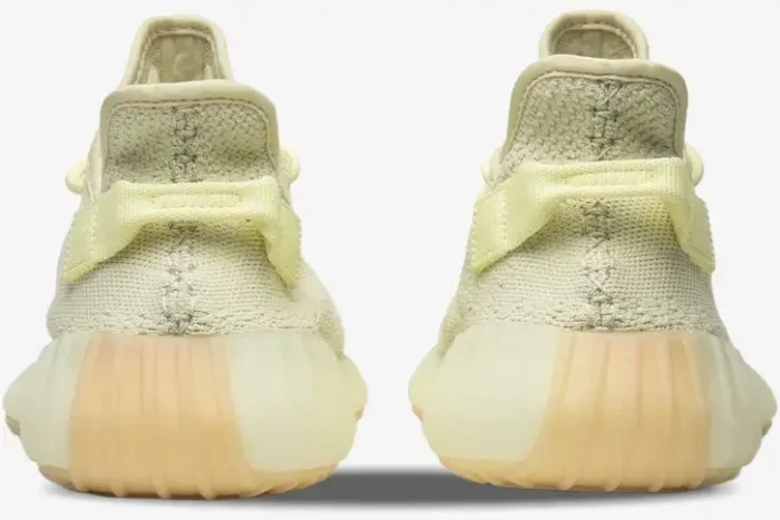 Rear view of Adidas Yeezy 350 V2 Butter sneakers showing the heel pull tabs and ribbed midsoles. - SKU F36980