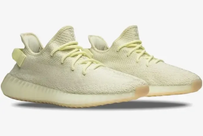 Side profile of Adidas Yeezy 350 V2 Butter sneakers with pale yellow Primeknit uppers and gum outsoles. - SKU F36980