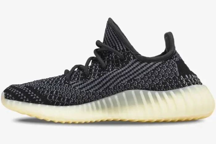 Side profile of Adidas Yeezy 350 V2 Carbon sneakers featuring a black and grey knit upper and cream midsole. - SKU FZ5000