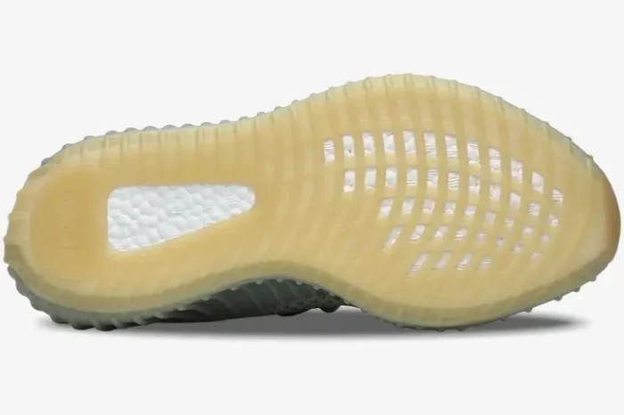 Bottom view of Adidas Yeezy 350 V2 Desert Sage sneakers showing the gum rubber outsole and white Boost cushioning. - SKU FX9035