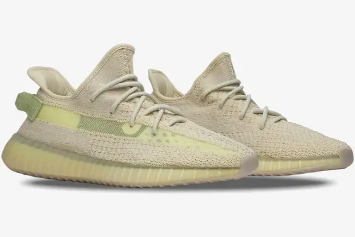 Side profile of Adidas Yeezy Boost 350 V2 Flax sneakers with beige Primeknit upper and translucent yellow midsole. - SKU FX9028