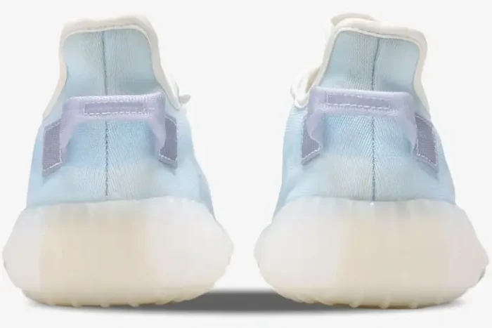 Rear view of light blue Adidas Yeezy 350 V2 Mono Ice sneakers with translucent soles and heel tabs. - SKU GW2869