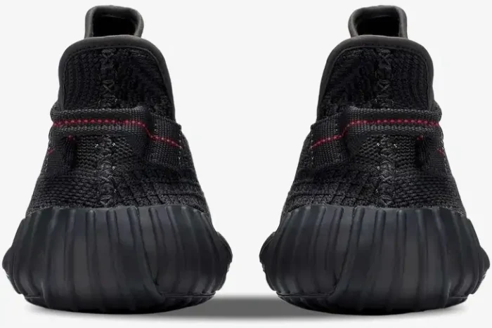 Rear view of Adidas Yeezy 350 V2 Static Black Non-Reflective sneakers with red heel tab stitching. - SKU FU9006