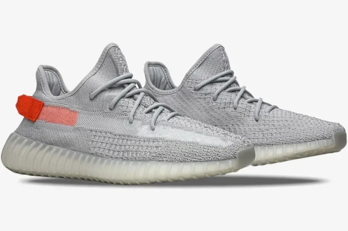 Side profile of Adidas Yeezy 350 V2 Tail Light sneakers in grey with an orange heel tab. - SKU FX9017