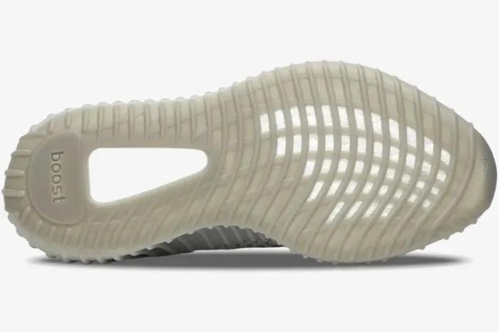 Bottom view of Adidas Yeezy 350 V2 Tail Light showing the translucent grey ribbed outsole and boost foam. - SKU FX9017