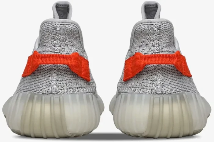 Rear view of Adidas Yeezy 350 V2 Tail Light sneakers in grey with bright orange heel tabs. - SKU FX9017