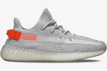 Side profile of Adidas Yeezy 350 V2 Tail Light in grey knit with bright orange heel accents. - SKU FX9017