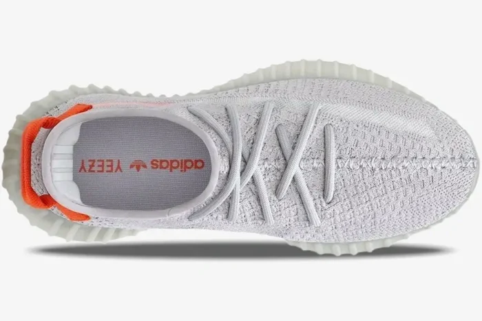 Top-down view of grey Adidas Yeezy 350 V2 Tail Light sneakers showing the laces and orange heel tab. - SKU FX9017