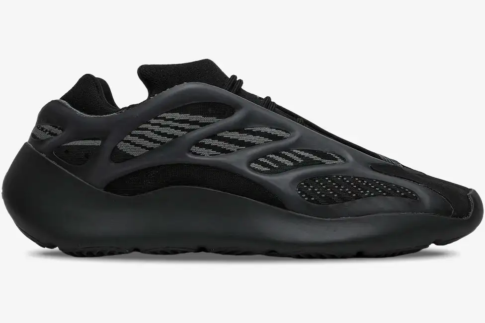 adidas-yeezy-700-v3-alvah-black-side-view-h67799-965-475 Side profile of the Adidas Yeezy 700 V3 Alvah sneaker in black and grey with a futuristic cage design. - SKU H67799