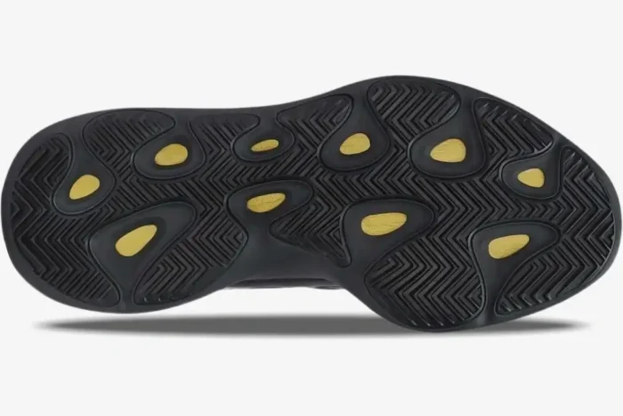 Bottom view of black Adidas Yeezy 700 V3 Alvah sneakers showing the textured outsole and yellow accents. - SKU H67799