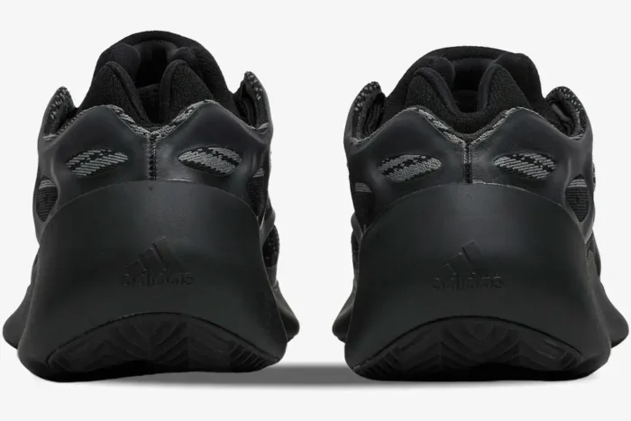 Rear view of Adidas Yeezy 700 V3 Alvah sneakers in black and grey, showing the heel and Adidas logo. - SKU H67799