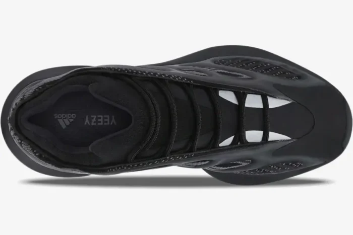 Top-down view of the Adidas Yeezy 700 V3 Alvah sneaker in triple black with mesh and RPU cage details. - SKU H67799