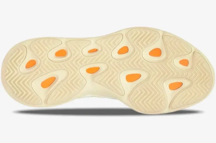 Bottom view of Adidas Yeezy 700 V3 Safflower sneakers showing cream outsole and orange details. - SKU G54853