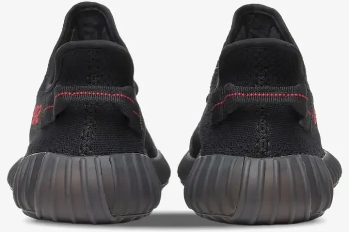 Rear view of Adidas Yeezy Boost 350 V2 Black Red sneakers showing the heel pull tabs and ribbed soles. - SKU CP9652