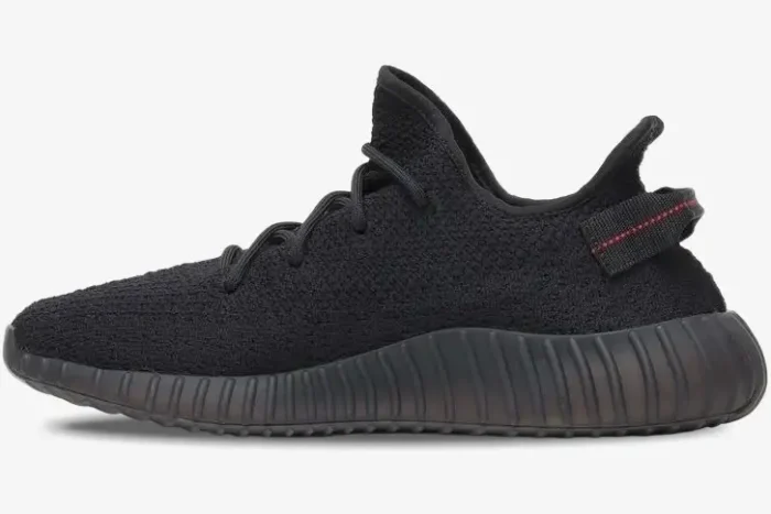 Side profile of Adidas Yeezy Boost 350 V2 in black with red heel tab stitching. - SKU CP9652