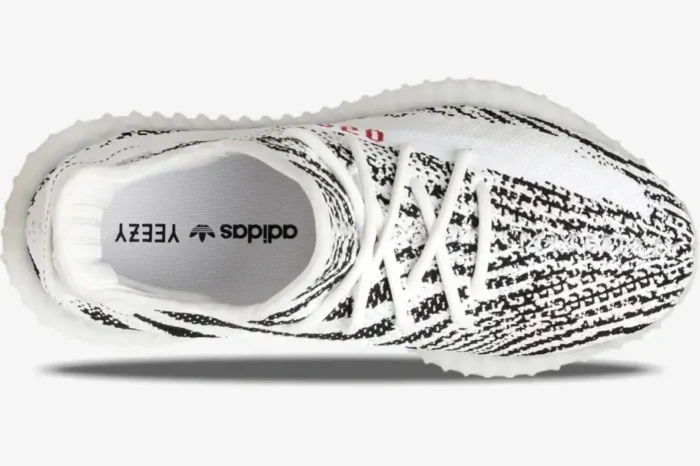 Top-down view of Adidas Yeezy Boost 350 V2 Zebra sneakers with white and black pattern and white laces. - SKU CP9654