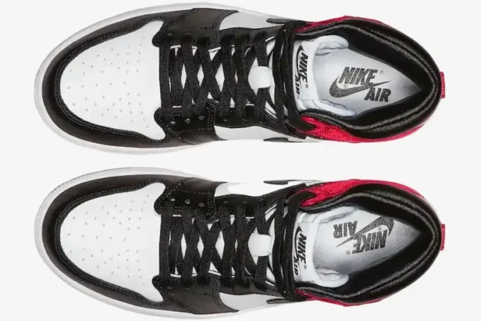 Top-down view of Air Jordan 1 High OG Bred Toe sneakers in white, black, and red with black laces. - SKU 555088-610