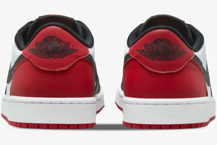 Rear view of Air Jordan 1 Low Black Toe sneakers with red heels and black wings logo. - SKU 553558-116