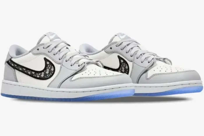 Air Jordan 1 Low Retro x Dior sneakers in white and grey, three-quarter view showing the Dior monogram swoosh. - SKU CN8608-002