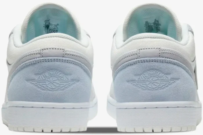 Rear view of Air Jordan 1 Low Paris City Pack sneakers in white and sky blue suede with embossed Wings logo. - SKU CV3043-100