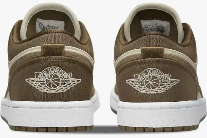 Rear view of Air Jordan 1 Low SE Light Olive sneakers showing embroidered Wings logo on the canvas heel. - SKU DV0426-301